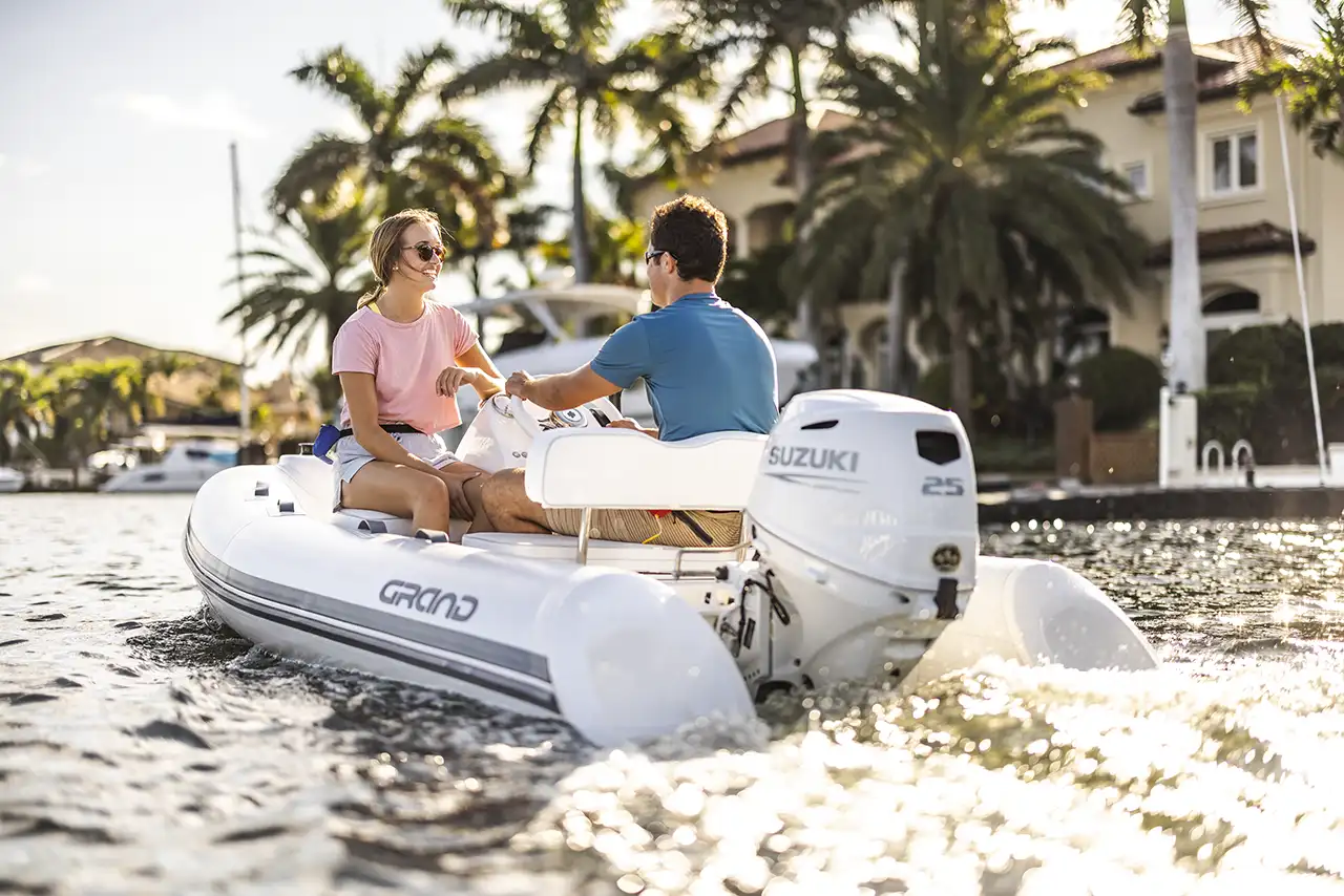 Frau und Kind sitzen auf einem Kleinboot mit einem Suzuki DF6a